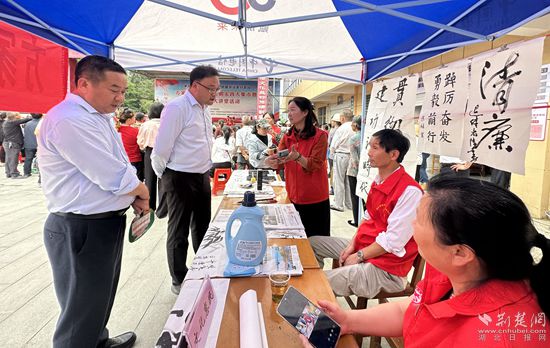 “文化惠民”攤位上，志愿者展示書法作品_副本.jpg